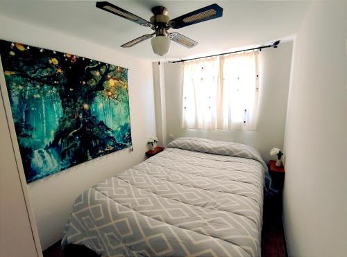 a bedroom with a bed and a ceiling fan at Casa Rural Villa Arizona en Cartagena in Murcia