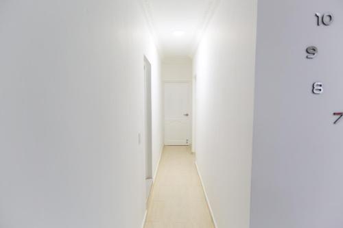an empty hallway with white walls and a white door at MB Apartment - B in San Felipe de Puerto Plata