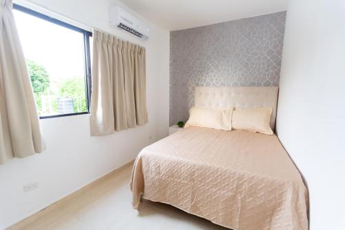 a bedroom with a bed and a window at MB Apartment - B in San Felipe de Puerto Plata