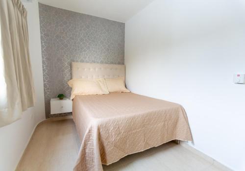 a bedroom with a bed in a white room at MB Apartment - B in San Felipe de Puerto Plata