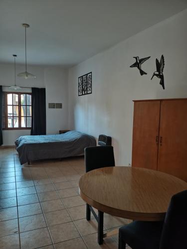a bedroom with a bed and a table and chairs at monoambiente malbec ubicacion privilegiada no mascotas in Mendoza