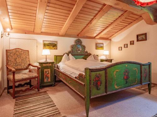 a bedroom with a large bed and a chair at Hochkönig in Kirchberg in Tirol