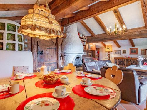 a dining room with a table and a fireplace at Hochkönig in Kirchberg in Tirol