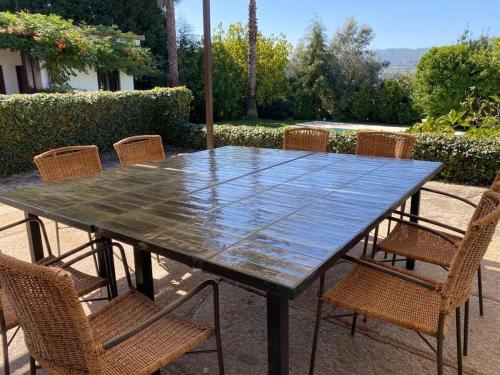 a wooden table with chairs and an umbrella at casa dos esteios in Penafiel