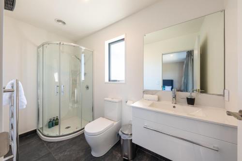 a bathroom with a toilet and a sink and a shower at Number 12 Apartment in Lake Tekapo