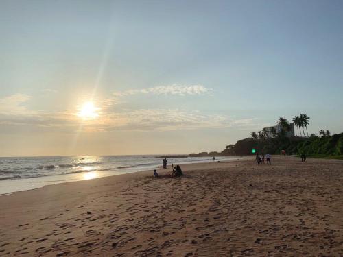 a group of people on the beach at sunset at The Tide's Tale in Galle