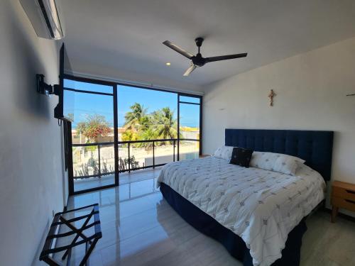 a bedroom with a bed and a view of the ocean at OLEA Beach Condos en Chicxulub Puerto in Chicxulub