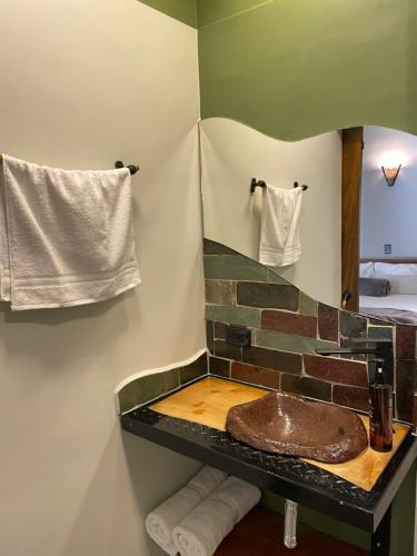a bathroom with a sink and a mirror at Hotel Casa Dulces del Jardín in Jardin
