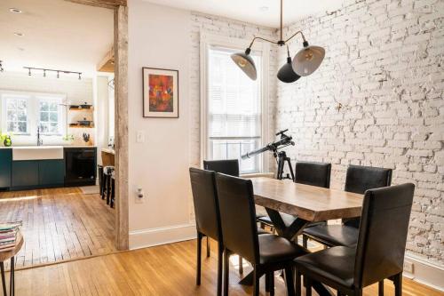 a dining room with a wooden table and black chairs at 3 minutes to downtown w/Patio, Art, Fire Pit, BBQ in Lancaster