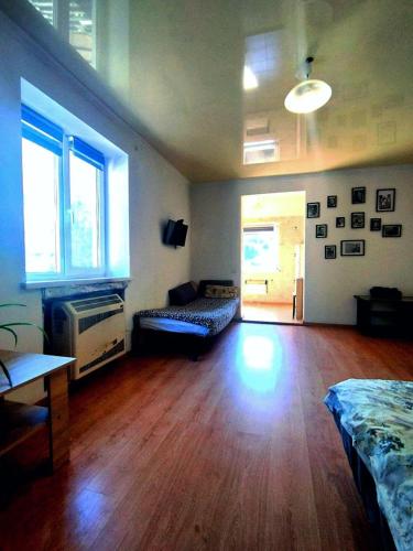 a living room with a hard wood floor and a couch at Apartments center - Затишні апартаменти в центрі біля ЦУМа in Poltava