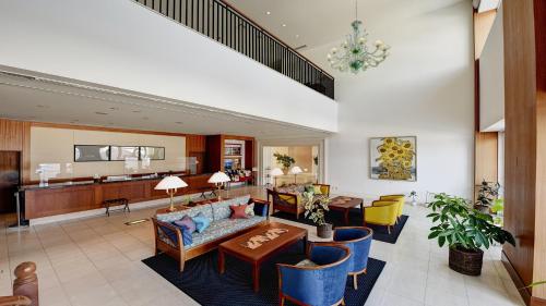 a living room with a couch and a table at Satoyama Auberge & Hot Spring Wellness Spa Sakuragaike Kurgarden in Nanto