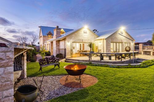 a house with a fire pit in the yard at Tulka House in Tulka