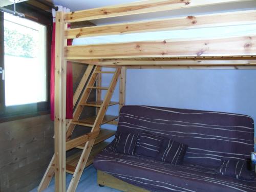 a bunk bed and a couch in a room at Appartement Châtel, 2 pièces, 4 personnes - FR-1-198-114 in Châtel
