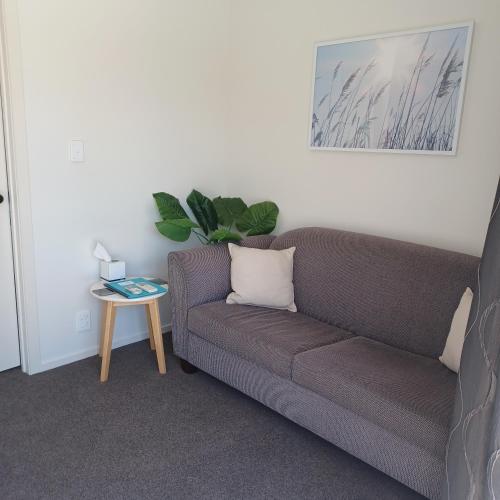 a living room with a couch and a table at Flaxbourne Motels in Ward