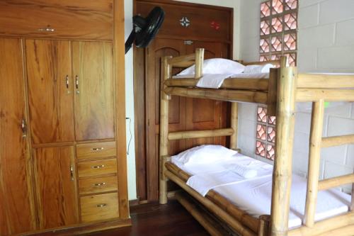 a bedroom with two bunk beds and a closet at AFRO HOSTEL in Necoclí