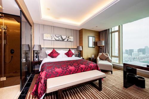 a hotel room with a bed and a large window at Shenzhen LANGYUE International Hotel in Longgang