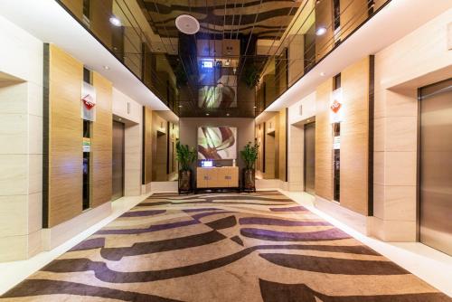 a hallway with a zebra patterned carpet in a building at Shenzhen LANGYUE International Hotel in Longgang