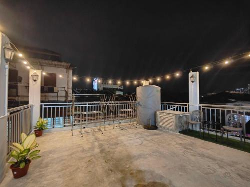 a balcony with lights on top of a building at Sunshine House in George Town