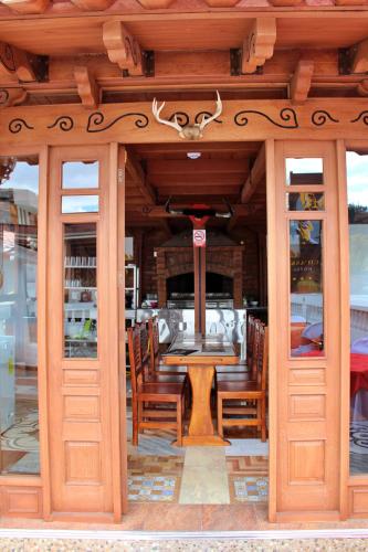 a restaurant with a table and chairs in a building at Chaska Hotel in Otavalo