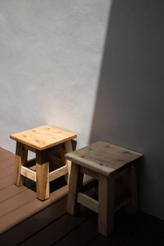 two wooden benches sitting next to each other on a deck at KVILLA in Ban Khlong Bang Chak