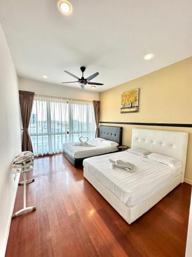 a bedroom with two beds and a ceiling fan at AJ Suites @ Loft Imago KK in Kota Kinabalu