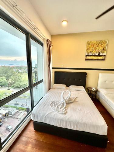 a bedroom with a bed and a large window at AJ Suites @ Loft Imago KK in Kota Kinabalu