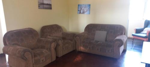 two chairs and a couch in a living room at Revive Haven Valley in Roodepoort