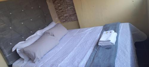 a bed with two towels sitting on top of it at Revive Haven Valley in Roodepoort