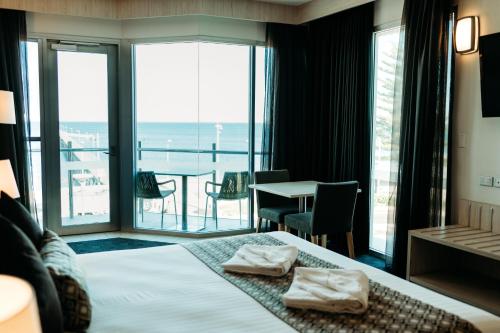 a hotel room with a bed and a view of the ocean at Ceduna Foreshore Hotel Motel in Ceduna