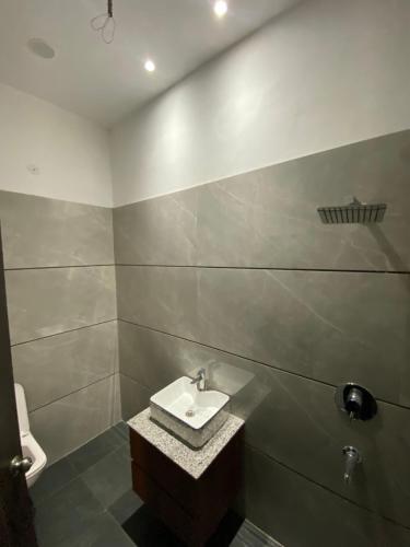 a bathroom with a sink and a toilet at Amritsar Homes - A perfect home away from home in Amritsar