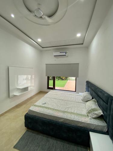 a bedroom with a bed in the middle of a room at Amritsar Homes - A perfect home away from home in Amritsar