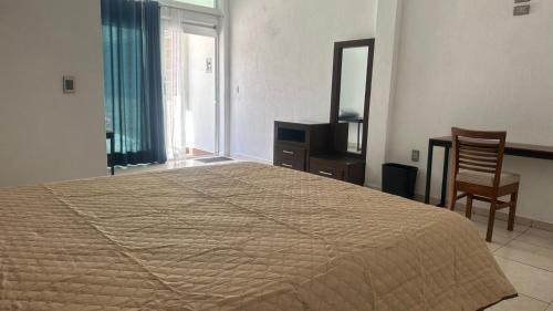 a bedroom with a bed and a dresser and a mirror at CASA BRAVO in Huamantla