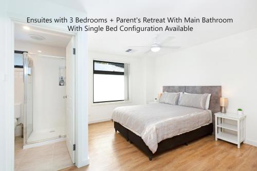 a white bedroom with a bed and a window at Agathas at Seacombe Gardens in Sturt