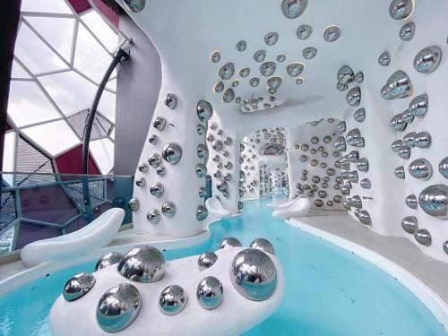 a water park with a pool with silver balls at ARTE+ Jalan Ampang in Kuala Lumpur