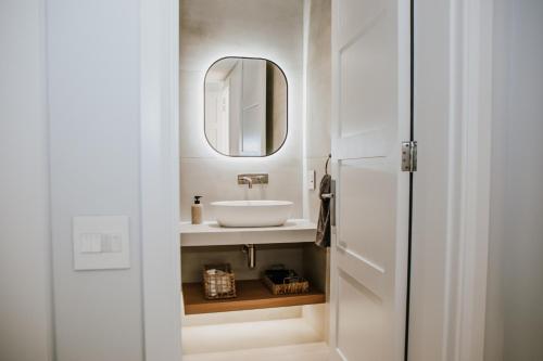 a bathroom with a sink and a mirror at Quiet Hideaway in Somerset West