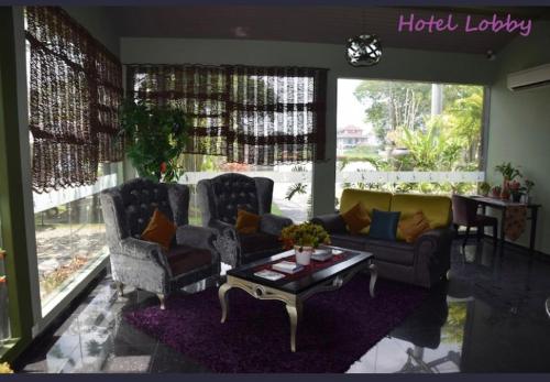 a living room with two couches and a coffee table at I Garden Hotel in Ipoh