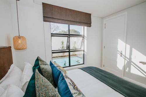 a bedroom with a bed and a window at Quiet Hideaway in Somerset West