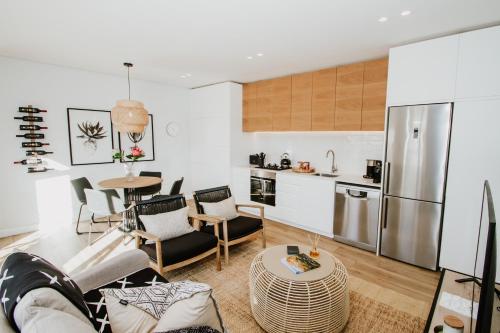 a kitchen and living room with a table and chairs at Quiet Hideaway in Somerset West