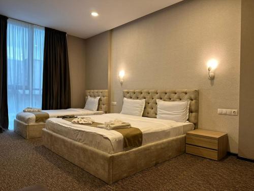 a hotel room with two beds and a window at Betlem Hotel -Tbilisi City in Tbilisi City