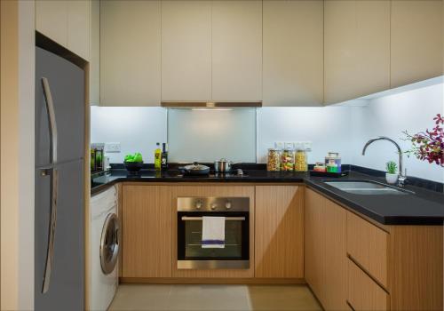 a kitchen with a sink and a dishwasher at Somerset Central TD Hai Phong City in Hai Phong