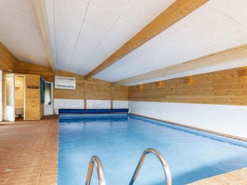 a large indoor swimming pool with wooden walls at 24 person holiday home in Læsø-By Traum in Læsø