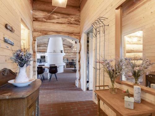a room with wooden walls and a hallway with vases on tables at 24 person holiday home in Læsø-By Traum in Læsø