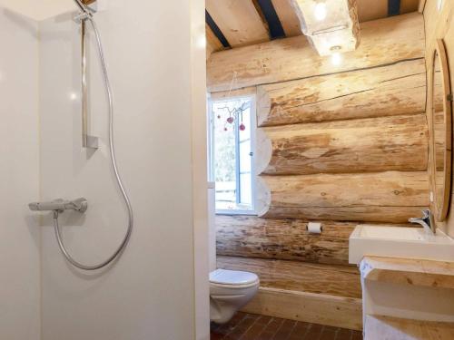 a bathroom with a wooden wall and a toilet at 24 person holiday home in Læsø-By Traum in Læsø