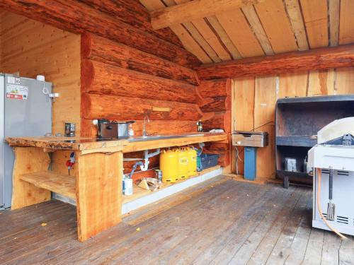 a kitchen in a log cabin with a stove at 24 person holiday home in Læsø-By Traum in Læsø