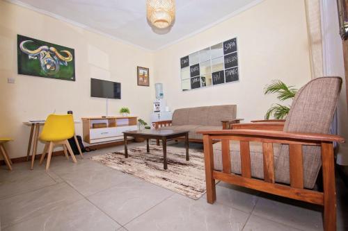 a living room with a couch and a table at Ebony Mara - Green House in Narok