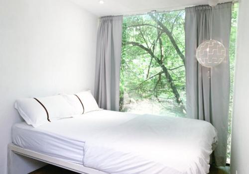 Voodi või voodid majutusasutuse Time Capsule Retreat, Sungai Lembing toas