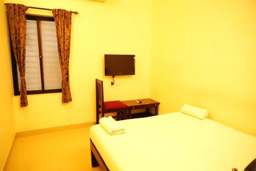 En eller flere senge i et værelse på sitthi residency