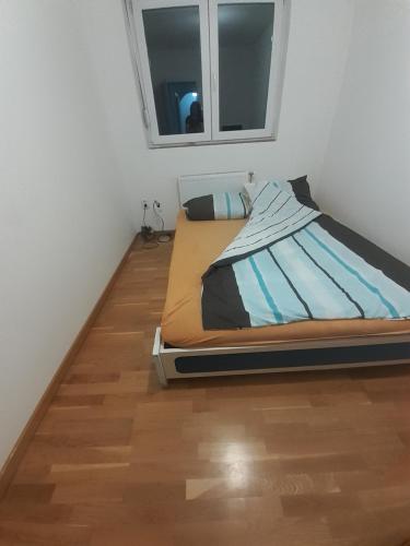 a bed in a room with a wooden floor at Dunav in Smederevo