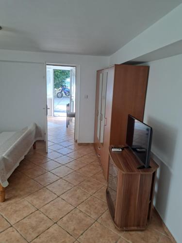 a living room with a television and a tiled floor at Apartments Pejanović in Kotor