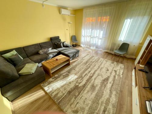 a living room with a couch and a rug at LOVEly Home&Lake in Balatonfüred